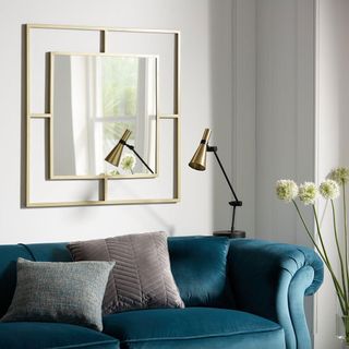 room with white wall blue sofa and cushion