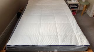 Image shows the Nectar Mattress placed on a wooden bed frame at our lead reviewer's home to expand fully