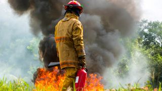 wildfire safety: fireman and a wildfire
