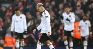 Manchester United players look dejected after Liverpool scored to make it 3-0 during the Premier League match between Liverpool FC and Manchester United at Anfield on March 5, 2023 in Liverpool, United Kingdom.
