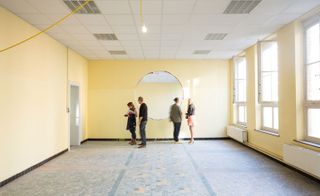 People standing in large yellow room