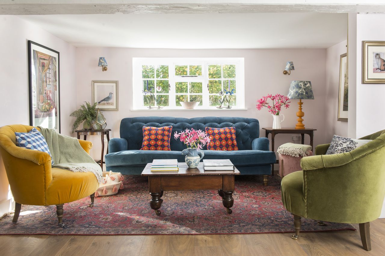 Blue velvet sofa, yellow and green armchair, wooden coffee table