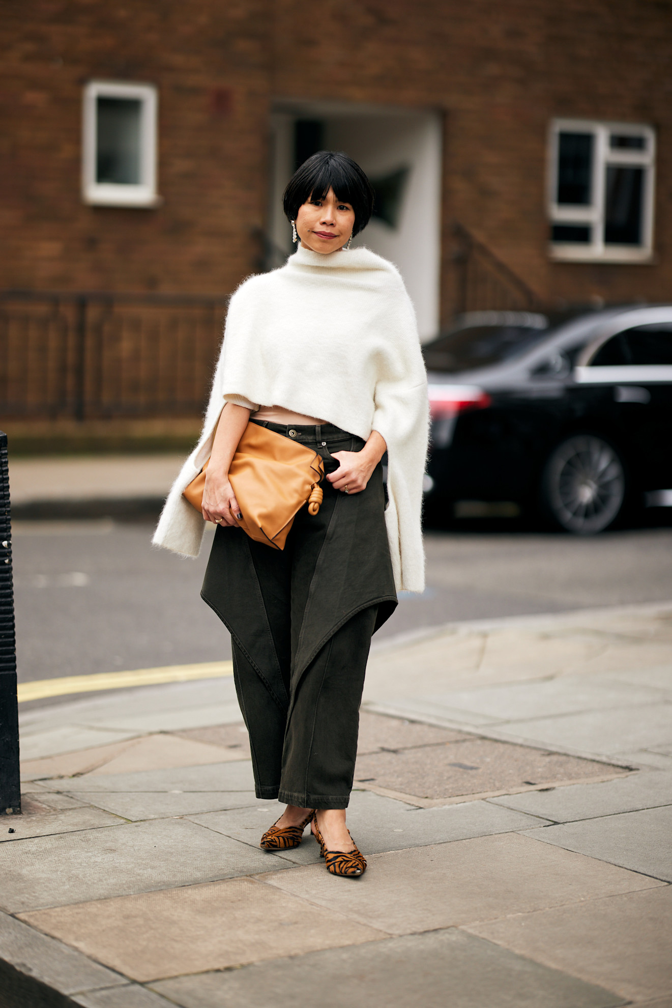 woman wearing a white poncho in London.