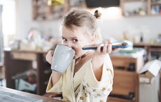 child with tea and smartphone