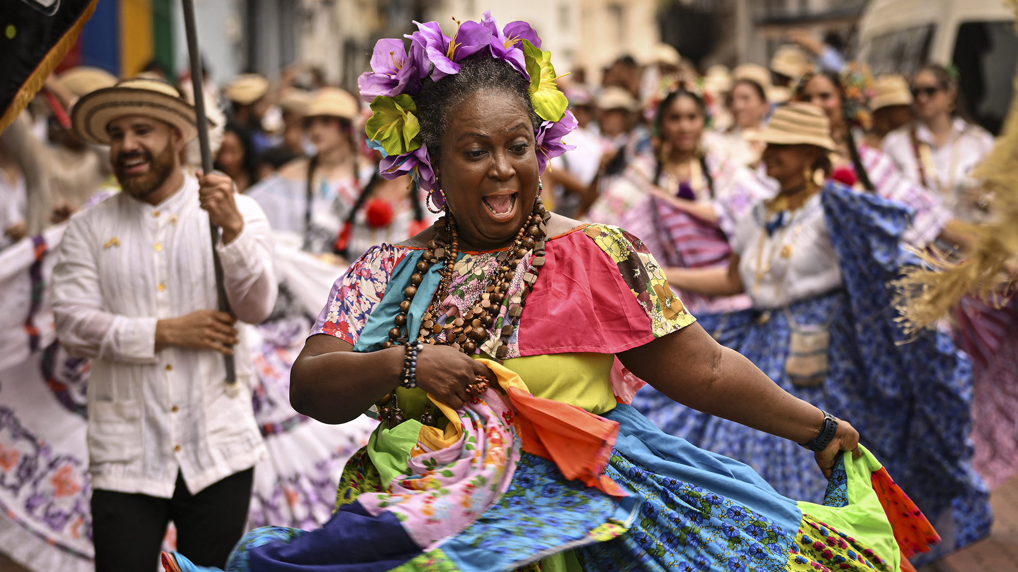 A woman dressed in a traditional costume dances during the Casco Peatonal celebrations in Panama City, Panama