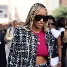 shiona turini wearing a tweed jacket and high waisted pants