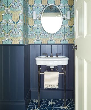 blue bathroom with patterned wallpaper and panelling