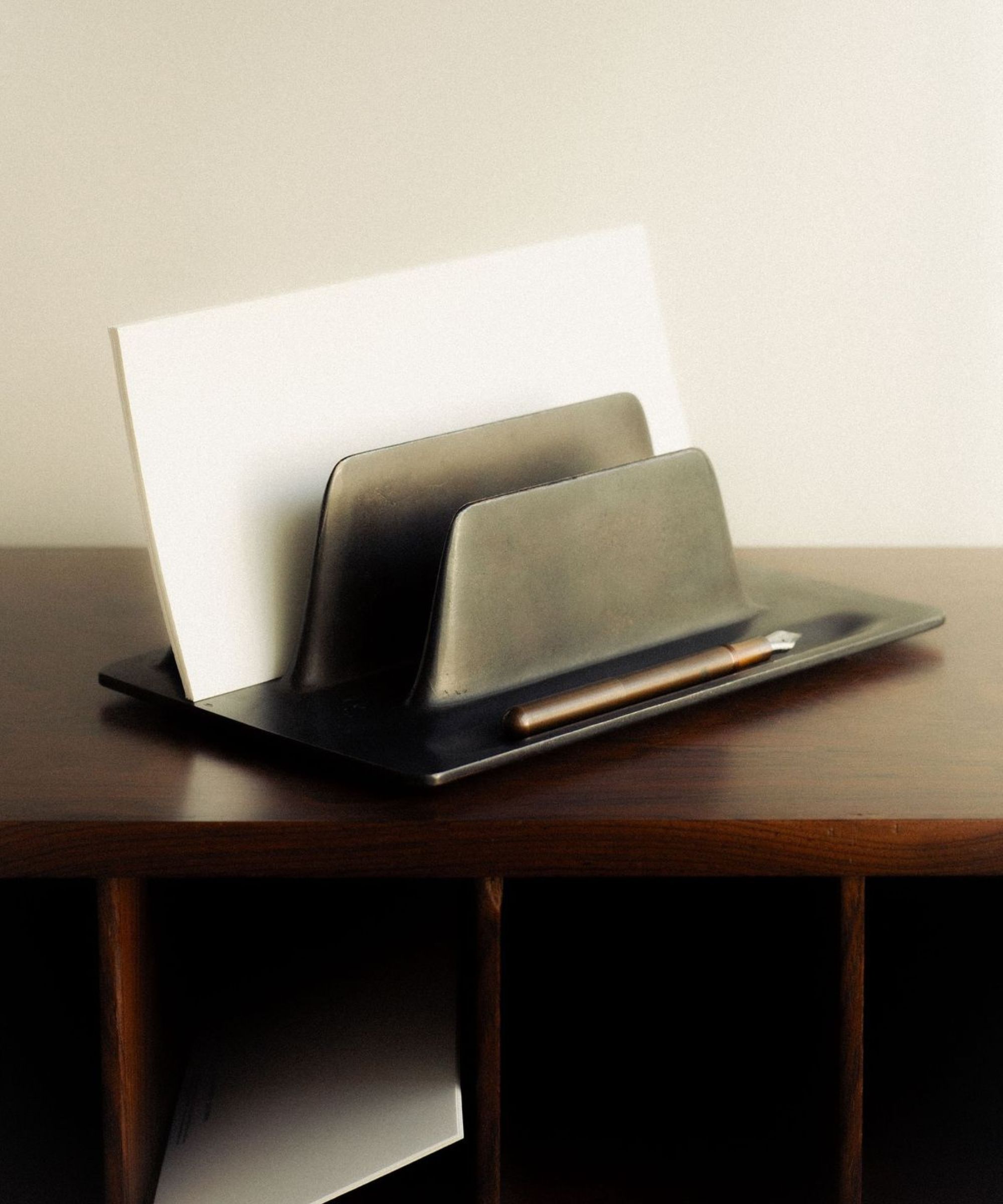 Metal file organizer placed on dark desk