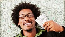 picture of a happy man surrounded by money and holding money