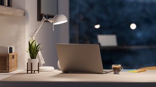 Modern home office room with laptop computer and desk lamp