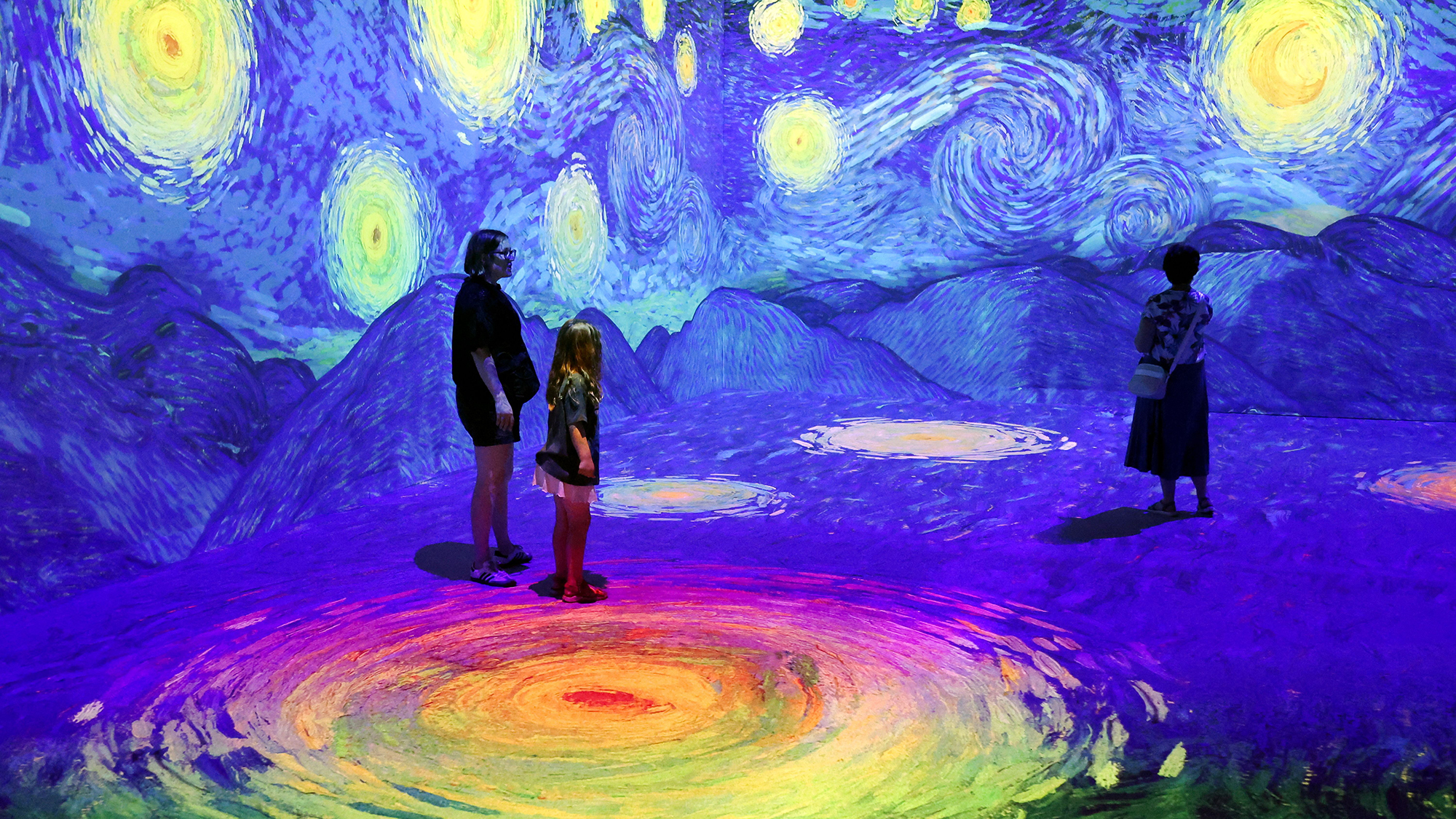 People wander through 360-degree digital projections as part of the 'Van Gogh: Immersive Experience' exhibition in Riga, Latvia
