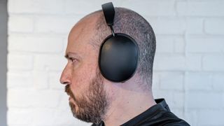 Wearing Sonos Ace headphones from side view.