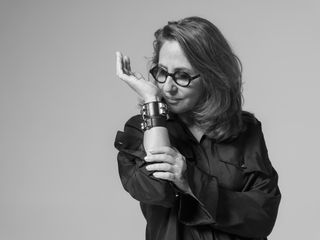 Perfumer Christine Nagel smelling fragrance on her wrist