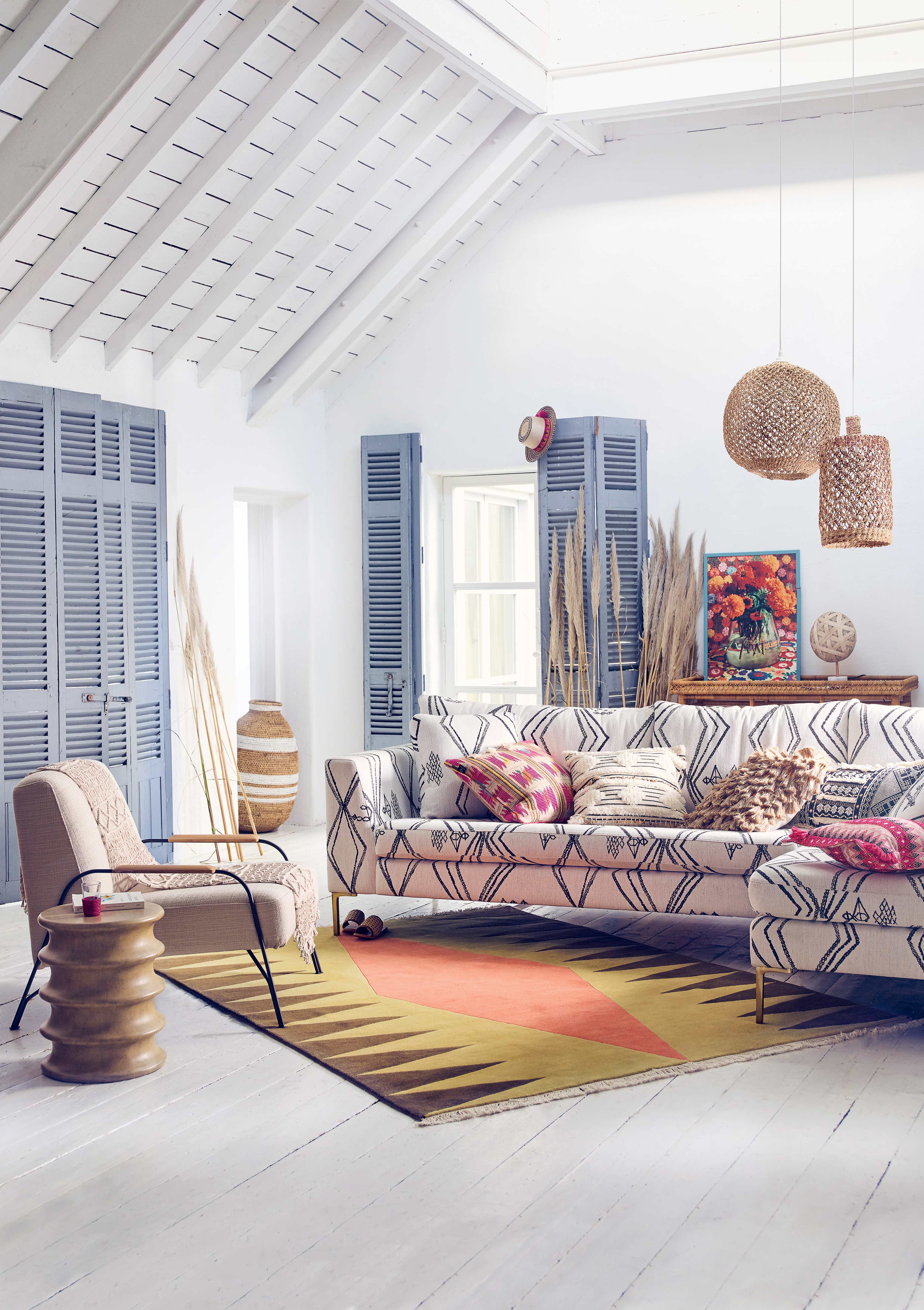 Ibiza style living room with patterned sofa and blue shutters