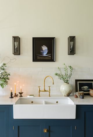 A farmhouse style sink with gold faucet