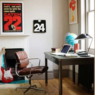 home office room with photo wall and desk lamp