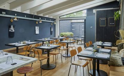 Restaurant with wooden floor and chair with black tables