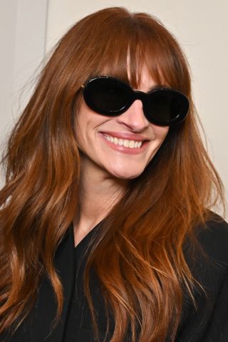 Julia Roberts is pictured with bright copper hair at the "The sculptures" Jacquemus' fashion show at the Fondation Maeght on January 29, 2024 in Saint-Paul-De-Vence, France.