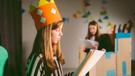 Young girl reading the script for a play