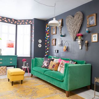 room with grey wall and green sofa