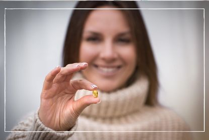 Woman holding a vitamin d supplement