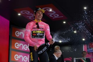 Roglic sprays the champagne on the podium