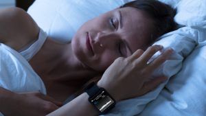 woman sleeping with fitness tracker