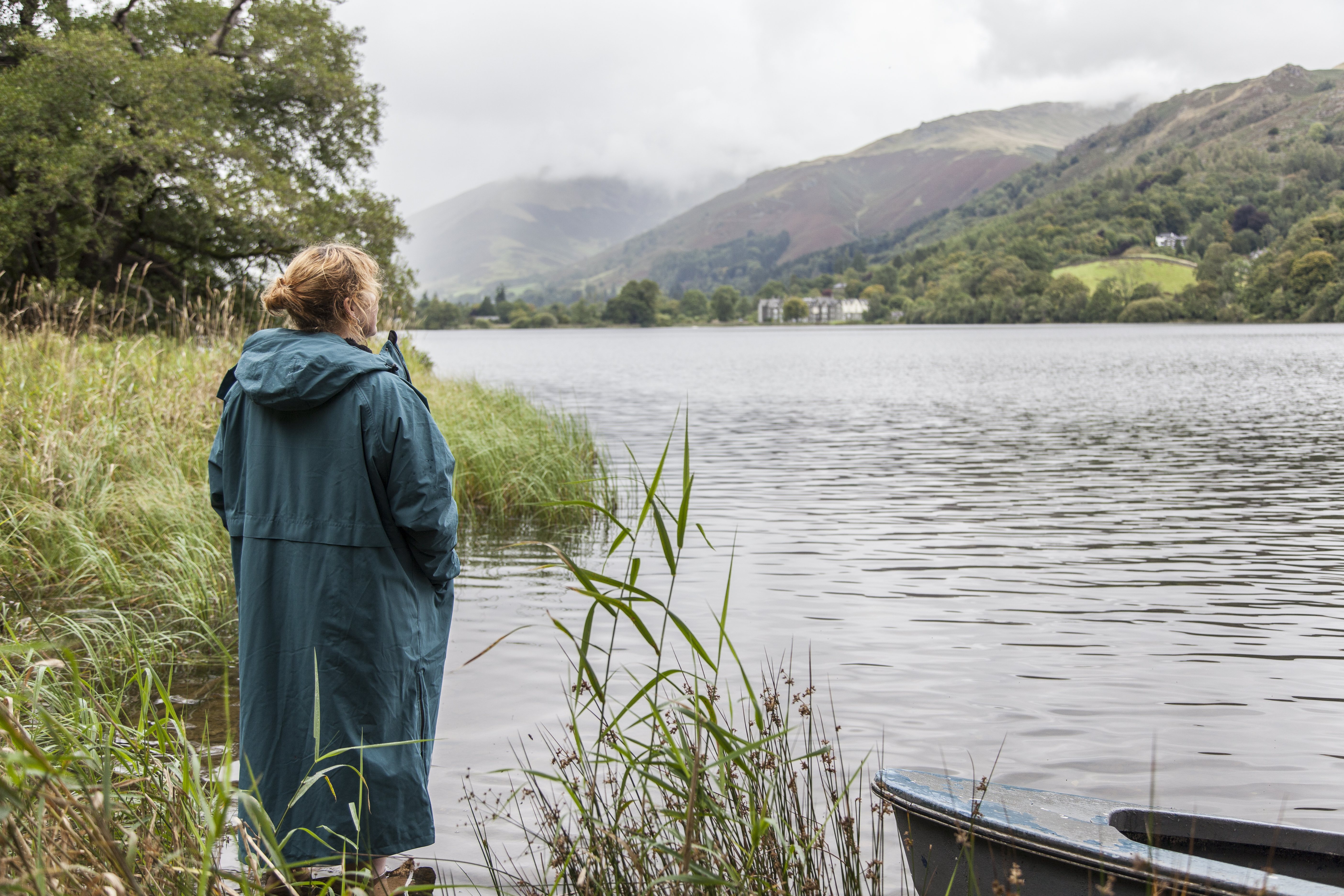 woman wearing Red Alter Evo standing on the banks of Grasmere lake in the Lake District