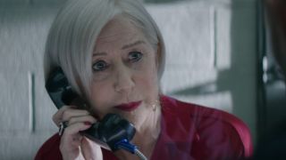 Helen Mirren talking into a prison phone in Hobbs and Shaw.