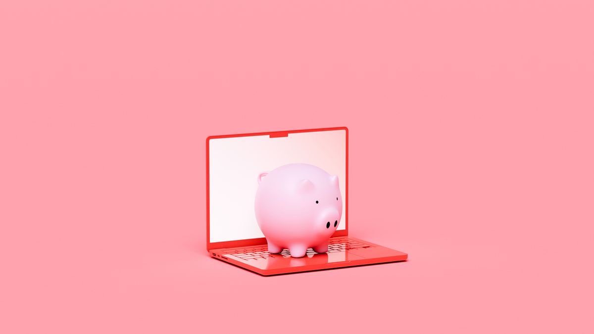 An image of a red laptop with a piggy bank sat on the keyboard