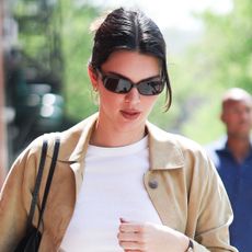 Kendall Jenner wears a white T-shirt with a suede jacket in NYC.