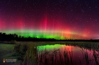 Aurora Borealis Arc Covers Night Sky Over Pond