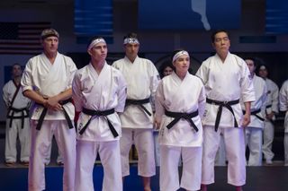 cobra kai cast in their karate uniforms at a competition in season 6 part 2