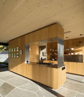 modern wooden kitchen with stone floor