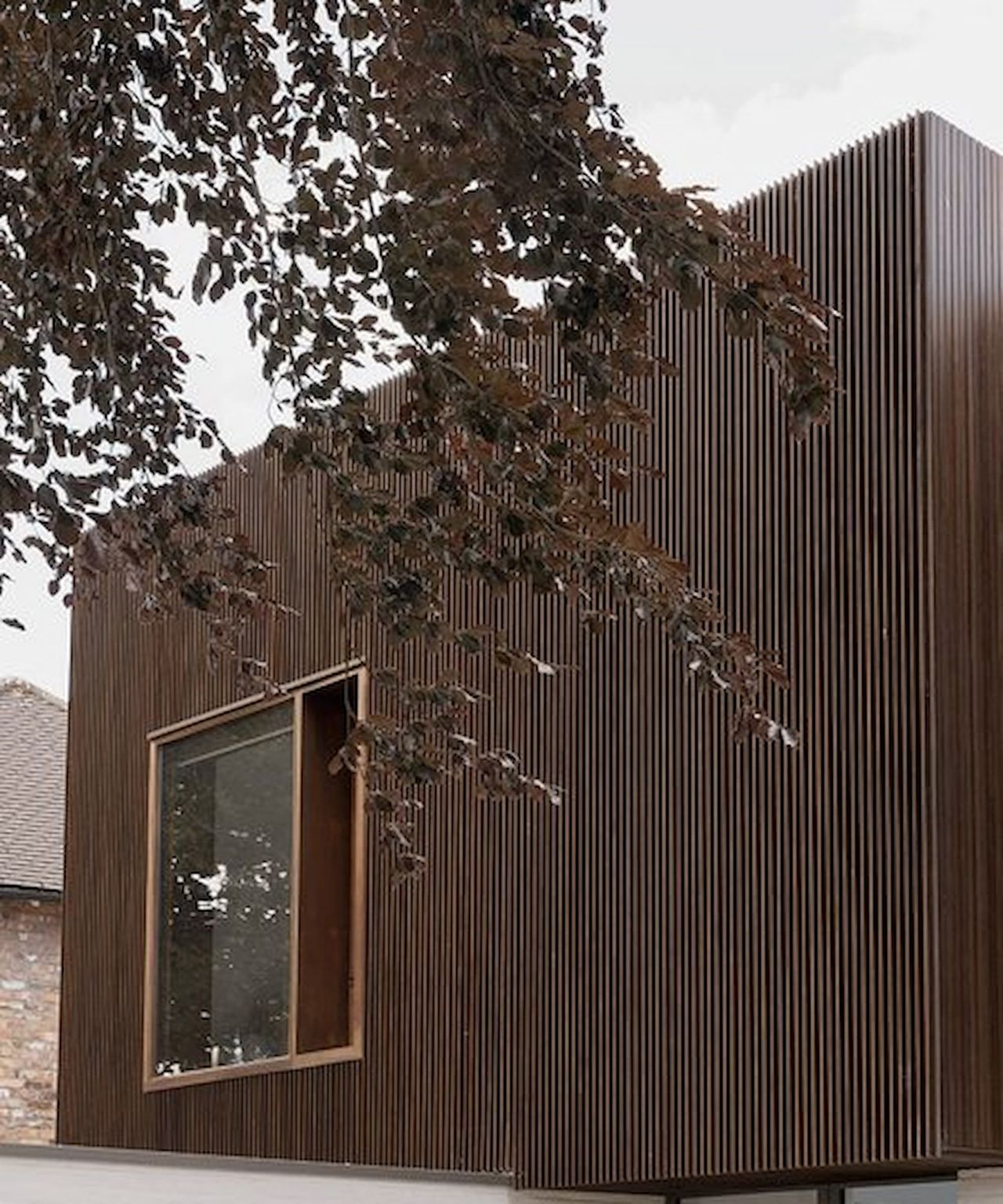The exterior of an upstairs self build showing timber panelling