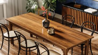 Wooden dining table with six bistro chairs in a dining room