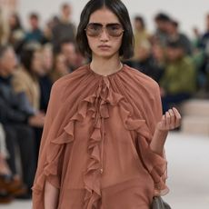 Woman in ruffle brown dress