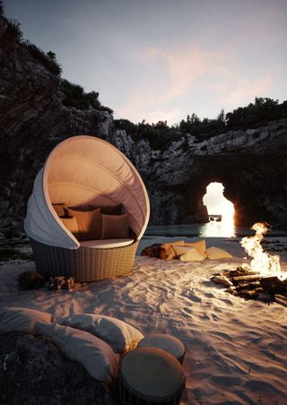 Orbit chair in beach cave by fire