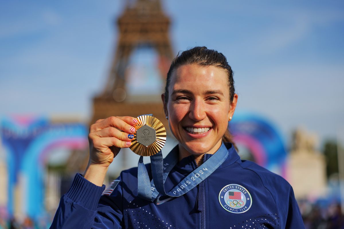 Kristen Faulkner (USA) celebrates with her Olympic Gold Medal after winning the Women&#039;s Road Race to become Olympic Champion in front of The Eiffel Tower