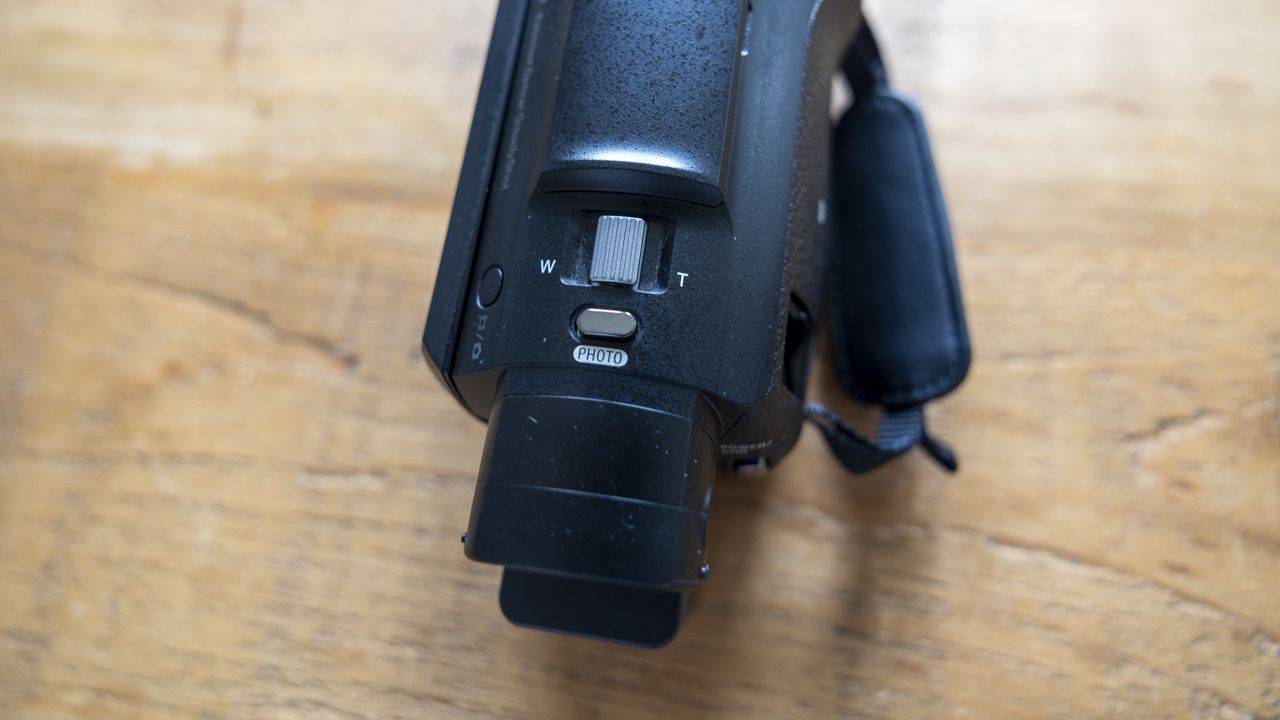 The Sony FDR-AX53 camcorder on a wooden table