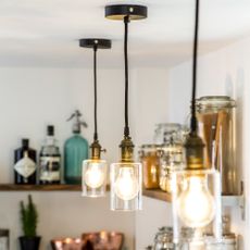 Three pendant lights with glass shades in kitchen 