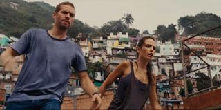 Brian O'Conner and Mia Toretto preparing to jump off a roof in Fast Five
