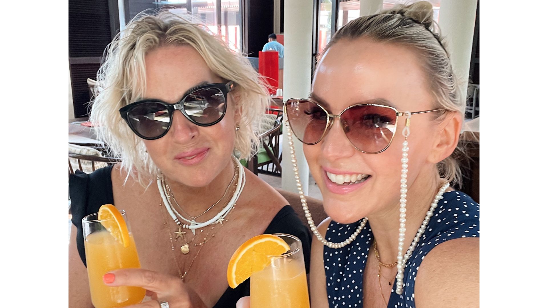 Kelly and her mum drinking orange juice on holiday