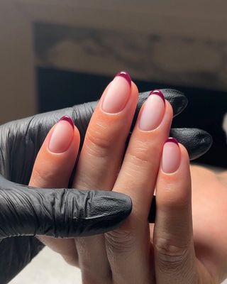 Dark red French manicure.