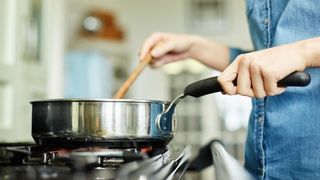 Woman cooking with a non-stick stainless steel pan