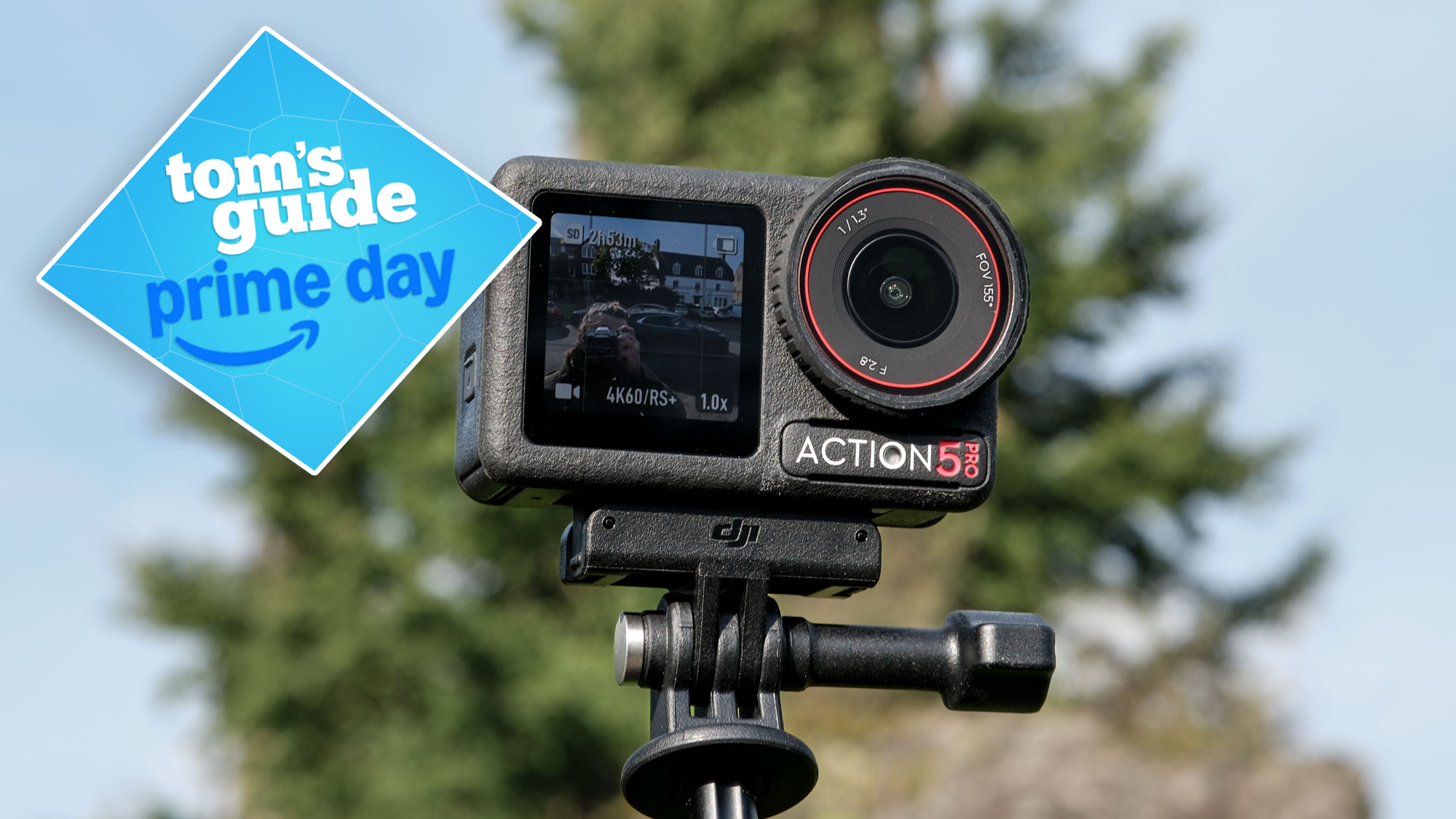 DJI Osmo Action 5 Pro against a blue sky with a tree in the background. A Tom&#039;s Guide Prime Day badge is on the left of the image.