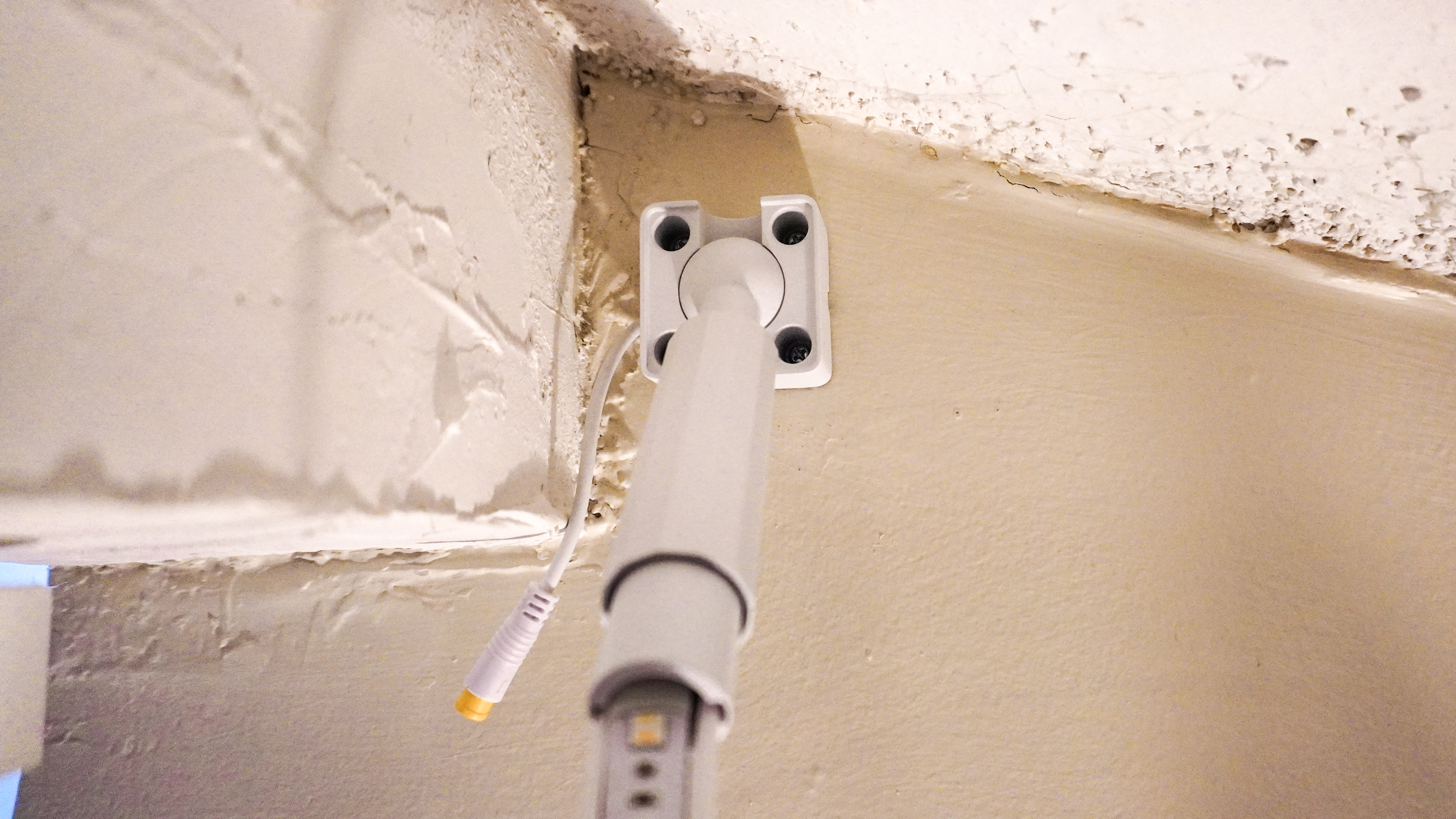 The mounting base of the Govee Strip Light with Skyline Kit installed on a wall behind a beam