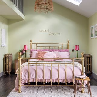 green bedroom with brass bed and pink bedding