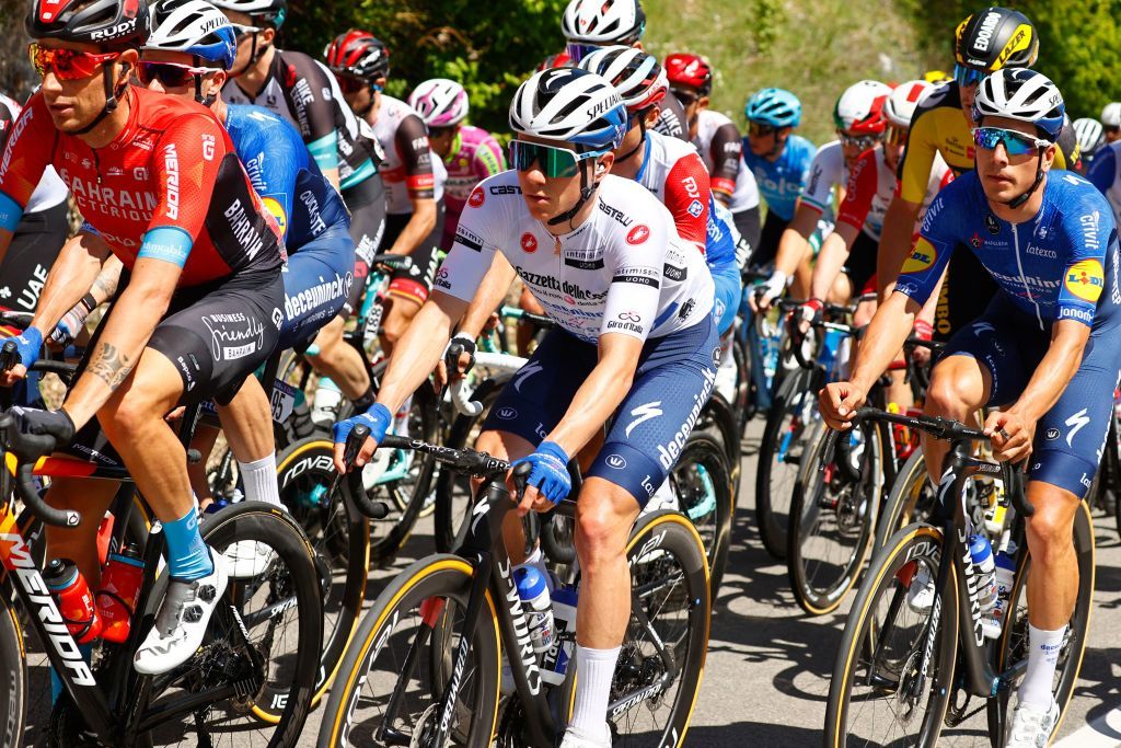 Team Deceuninck rider Belgiums Remco Evenepoel C rides during the tenth stage of the Giro dItalia 2021 cycling race 139 km between lAquila and Foligno on May 17 2021 Photo by Luca Bettini AFP Photo by LUCA BETTINIAFP via Getty Images
