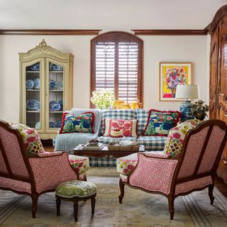 living room floral print chairs gingham sofa glazed china cabinet and shutters